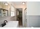 Bright bathroom featuring a walk-in shower, updated vanity, and wood floors at 1703 Alton Way, Marietta, GA 30062