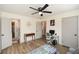 Bedroom featuring wood-look floors, a ceiling fan, and an adjacent full bathroom; ideal for use as a home office at 1703 Alton Way, Marietta, GA 30062