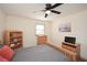Bedroom features natural wood furnishings, a ceiling fan, and a window providing plenty of natural light at 1703 Alton Way, Marietta, GA 30062