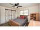 Bedroom featuring wood-look floors, ceiling fan, and a large closet with stylish sliding doors at 1703 Alton Way, Marietta, GA 30062