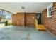 Brick carport with new-looking wood stairs leading into the house at 1703 Alton Way, Marietta, GA 30062