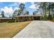 Brick home with a long driveway and covered parking area at 1703 Alton Way, Marietta, GA 30062