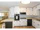Eat-in kitchen with white cabinets, granite counters, stainless steel appliances, and breakfast bar at 1703 Alton Way, Marietta, GA 30062