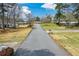 An eye level image of street highlighting houses and neighborhood's picturesque scenery at 1703 Alton Way, Marietta, GA 30062