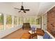 Sunroom with abundant natural light and views of the backyard. The room features a ceiling fan and access to the exterior at 1703 Alton Way, Marietta, GA 30062