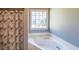 Bathroom featuring a tub with tile surround and a shower curtain at 2037 Castlemaine Circle, Woodstock, GA 30189