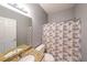 Bathroom features granite countertop, shower with patterned curtain, and neutral color palette at 2037 Castlemaine Circle, Woodstock, GA 30189