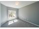 The bedroom features natural light, neutral walls, and cozy carpet at 2037 Castlemaine Circle, Woodstock, GA 30189