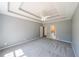 Carpeted bedroom featuring a trey ceiling with a ceiling fan at 2037 Castlemaine Circle, Woodstock, GA 30189
