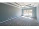 Spacious bedroom with a tray ceiling, neutral carpet, and a view of the backyard at 2037 Castlemaine Circle, Woodstock, GA 30189