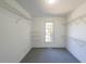 Walk-in closet with gray carpet, metal shelving, and a window for natural light at 2037 Castlemaine Circle, Woodstock, GA 30189