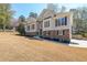 Well-maintained home featuring light siding with stone accents, enhanced by a lush, green yard at 2037 Castlemaine Circle, Woodstock, GA 30189