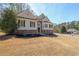 Beautiful home featuring beige siding and a stacked stone facade, enhanced by a lush green lawn at 2037 Castlemaine Circle, Woodstock, GA 30189