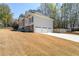 Spacious three-car garage adjacent to a home with light siding and manicured lawns on a sunny day at 2037 Castlemaine Circle, Woodstock, GA 30189