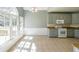 Bright eat-in kitchen with tile floors, gray cabinets, granite counters, and plenty of sunlight at 2037 Castlemaine Circle, Woodstock, GA 30189