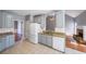 Well-lit kitchen featuring granite counters, gray cabinets, and stainless steel appliances with tile floors at 2037 Castlemaine Circle, Woodstock, GA 30189