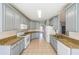 Well-appointed kitchen featuring gray cabinetry, granite countertops, and tile flooring for a modern feel at 2037 Castlemaine Circle, Woodstock, GA 30189