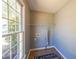 Small laundry room with tile floors, window with natural light, and includes a shelf and mat at 2037 Castlemaine Circle, Woodstock, GA 30189