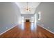 Spacious living room with hardwood floors, a fireplace, and large windows offering ample natural light at 2037 Castlemaine Circle, Woodstock, GA 30189