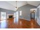 Open living room featuring hardwood floors, a fireplace, and large windows offering abundant natural light at 2037 Castlemaine Circle, Woodstock, GA 30189
