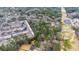 Aerial view showcasing the wooded area adjacent to townhomes and other residences, offering building possibilities at 2469 Stone Rd, East Point, GA 30344