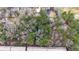 The birds-eye view showcases a wooded lot near dense townhomes and a neighborhood of single Gathering residences at 2469 Stone Rd, East Point, GA 30344