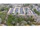 Aerial view showing complex with mature trees, a pool, and parking at 2469 Stone Rd, East Point, GA 30344