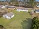Aerial view of the home with a lush green lawn, detached garage, and plenty of space for outdoor activities at 708 Morris Rd, Hiram, GA 30141