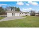 A large backyard features a concrete patio and a view of the rear of the house at 708 Morris Rd, Hiram, GA 30141