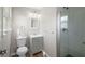 A bathroom features a shower with glass doors, a toilet and a grey vanity at 708 Morris Rd, Hiram, GA 30141