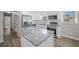 Well-lit kitchen with stainless appliances, white cabinets, and a granite-top island at 708 Morris Rd, Hiram, GA 30141
