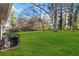 Lush green backyard with mature trees and air conditioning unit at 1894 Evans Sw Dr, Atlanta, GA 30310