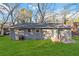 Grey brick exterior of home featuring a green lawn, trees and windows at 1894 Evans Sw Dr, Atlanta, GA 30310