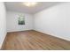 Bright bedroom with neutral walls and wood-look floors, offering a serene and adaptable space at 1894 Evans Sw Dr, Atlanta, GA 30310