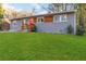 Charming gray brick home featuring a bright orange front door and a well-maintained green lawn at 1894 Evans Sw Dr, Atlanta, GA 30310