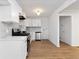 Modern kitchen featuring white cabinetry, stainless steel appliances, and sleek countertops and backsplash at 1894 Evans Sw Dr, Atlanta, GA 30310