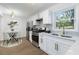 Bright kitchen with modern appliances, white cabinetry, and an adjacent dining area, perfect for cooking at 1894 Evans Sw Dr, Atlanta, GA 30310