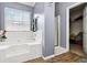Well lit bathroom featuring a bathtub, shower, and spacious closet at 6274 Katelyn Park, Lithonia, GA 30058