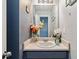 Bathroom with vanity, decorative mirror, flowers, and accent decor at 6274 Katelyn Park, Lithonia, GA 30058