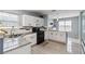 Well-lit kitchen featuring white cabinetry, granite countertops, stainless steel appliances, and wood-look tile flooring at 6274 Katelyn Park, Lithonia, GA 30058