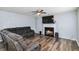 Inviting living room featuring wood flooring, a fireplace, a ceiling fan, and a comfortable reclining sectional sofa at 6274 Katelyn Park, Lithonia, GA 30058