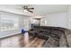 Spacious living room featuring wood flooring, a ceiling fan, a sectional sofa and a view of the kitchen at 6274 Katelyn Park, Lithonia, GA 30058