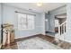 Open-concept living room showing wood flooring and light blue walls with a view of the entryway and staircase at 6274 Katelyn Park, Lithonia, GA 30058