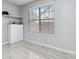 Bright room featuring a large window, wood floors, and white cabinet storage at 6274 Katelyn Park, Lithonia, GA 30058