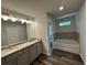 Bathroom featuring double sinks, granite countertops, and a soaking tub at 75 Pine Creek Ct, Dallas, GA 30157