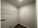 Small laundry room with washer and dryer hookups and a wire shelf for storage at 75 Pine Creek Ct, Dallas, GA 30157