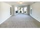 A bright living room featuring large windows and neutral carpet at 1576 Smithson Dr, Lithonia, GA 30058