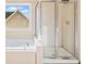 A glass shower and soaking tub are the focal points of the bathroom, offering comfort and style at 217 Park Creek Dr, Woodstock, GA 30188