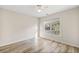 The bedroom has neutral walls, wood-look flooring, and a ceiling fan for added comfort at 217 Park Creek Dr, Woodstock, GA 30188