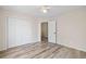 Bedroom featuring wood-look floors, a ceiling fan, and a double closet, ready for decor at 217 Park Creek Dr, Woodstock, GA 30188